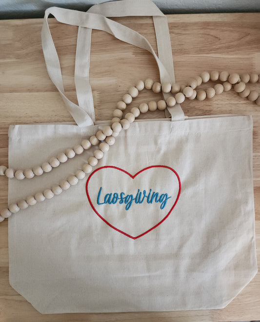 Beige tote bag with custom text and design, like "Laosgiving."